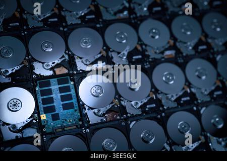 hi resolution photograph wallpaper of numbers of hard drives show inside metal disk and parts in pattern with focusing on the one of circuit of solid Stock Photo