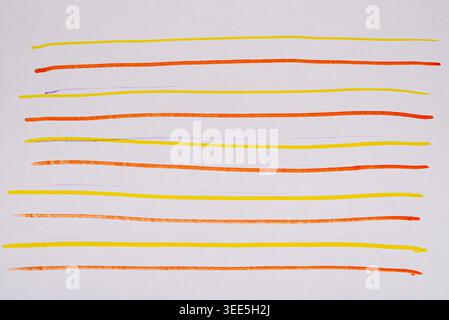 Textured background of orange, yellow and purple horizontal lines drawn with markers on white paper Stock Photo