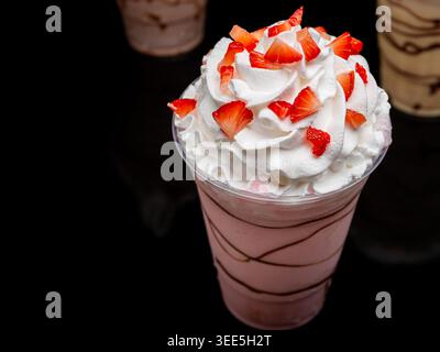 Indulge in a refreshing strawberry milkshake served in a clear plastic cup Stock Photo