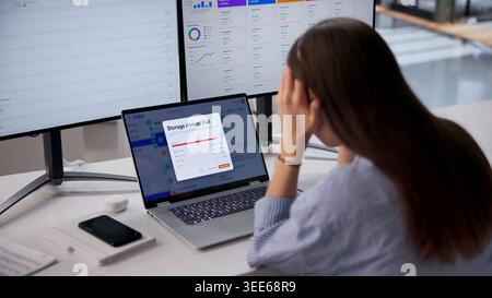 Woman Using Laptop Feels Stressed Facing Full Email Storage Problem. Stock Photo