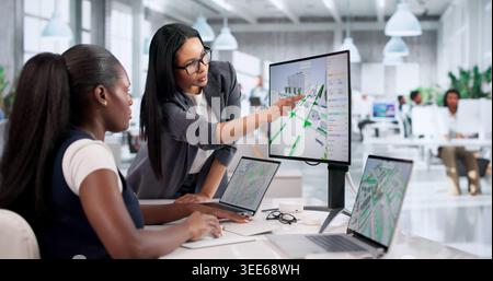 Civil Engineer Reviews Traffic Flow Data On Laptop For City Road Planning. Stock Photo
