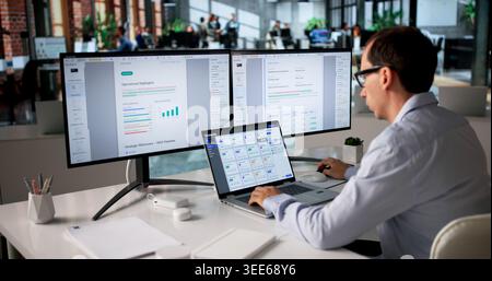 Office Manager Organizes Files On Computer Using Secure Document Management System. Stock Photo