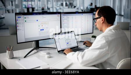 Healthcare Billing Manager Reviews Patient Claims Using Laptop System Daily. Stock Photo