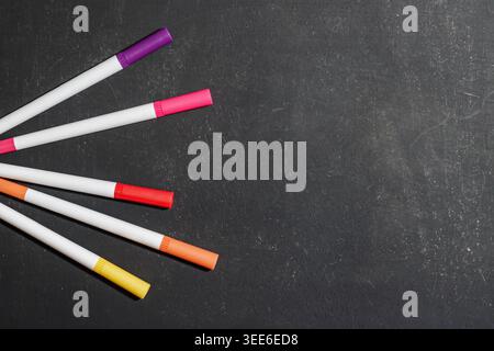 Colorful markers arranged in a fan shape on a dark background. Drawing Supplies. Education and Learning Concept. High quality photo Stock Photo