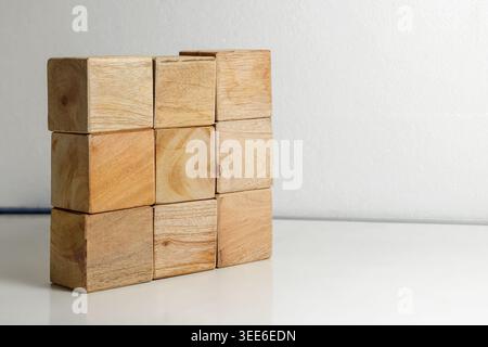 Nine Wooden Blocks Stacked on a White Surface. Wooden Blocks. Childhood Creativity. Learning and Education Concept. High quality photo Stock Photo