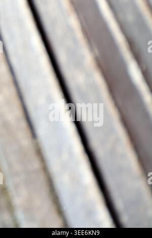 Abstract background with blurred diagonal lines showing a minimalist texture of weathered wooden slats under bright natural light Stock Photo