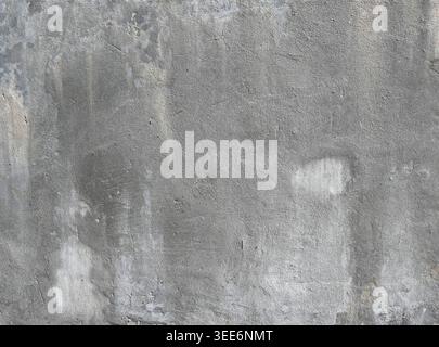 Close up of weathered rough gray concrete wall surface with textured indentations, crevasses, and visible scrapes Stock Photo
