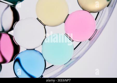 Colorful translucent glass spheres in petri dish forming minimalist abstract pattern Stock Photo