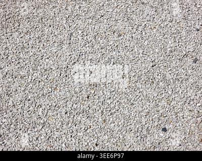Close up of rough concrete surface texture background showing grey stone and gravel pattern creating calm solid feeling with abstract grain and macro Stock Photo
