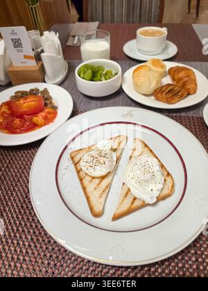 Breakfast with poached eggs on toasted bread Stock Photo