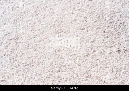 Granular white surface features a detailed crystalline texture, ideal for salt, sand, or snow-themed backgrounds in commercial and creative designs. Stock Photo