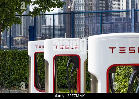 Tesla electric vehicle charging stations in an outdoor parking lot. London, UK, 19 May 2024 Stock Photo