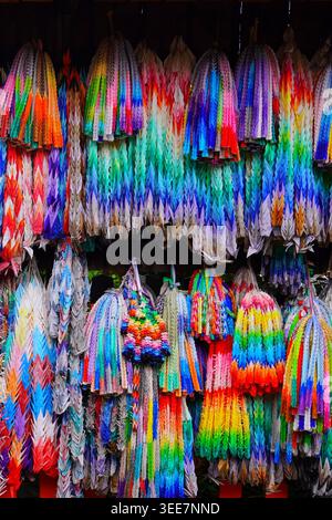 Colorful origami paper cranes hanging in Japanese shrine temple Stock Photo