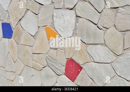 TEXTURE BACKGROUND OF A WALL WITH SOME COLORED BRICKS Stock Photo
