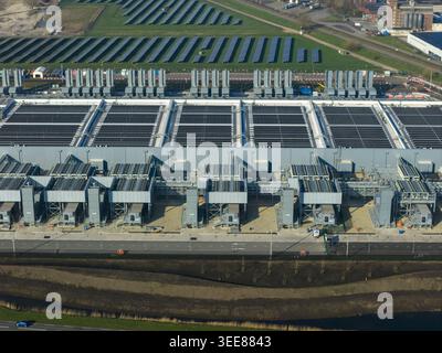 Aerial view of the Google data center featuring large industrial cooling units and solar panel arrays in Winschoten, Groningen, Netherlands. Stock Photo