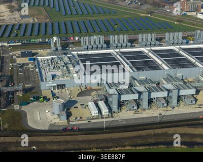 Aerial view of the Google data center featuring large industrial buildings, cooling units, and a solar panel farm in Winschoten, Groningen, Netherland Stock Photo