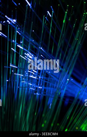Futuristic abstract image featuring blue fiber optic light trails and glowing lines with depth perspective. Suitable for themes related to telecommuni Stock Photo