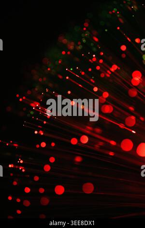 Futuristic abstract image of glowing red optical fiber lights with selective focus and bokeh effects. Ideal for concepts related to internet technolog Stock Photo