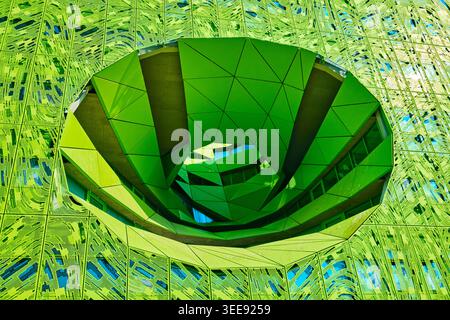 Lyon, France - March 19, 2026: The Euronews Headquarters by Jakob + MacFarlane, featuring a vibrant green perforated facade and large circular voids Stock Photo