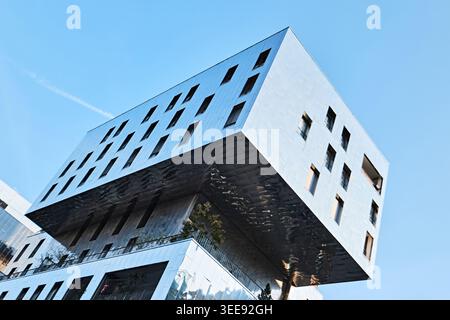 Lyon, France - March 19, 2026: Modern contemporary architecture in the Confluence district featuring a cantilevered structure with reflective surfaces Stock Photo