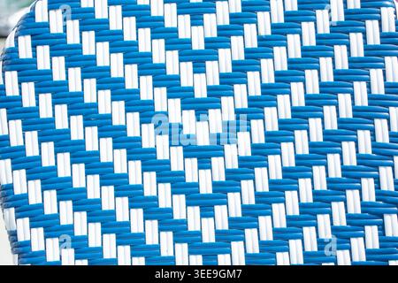 A closeup view of a blue and white wicker weave design, as a background. Stock Photo
