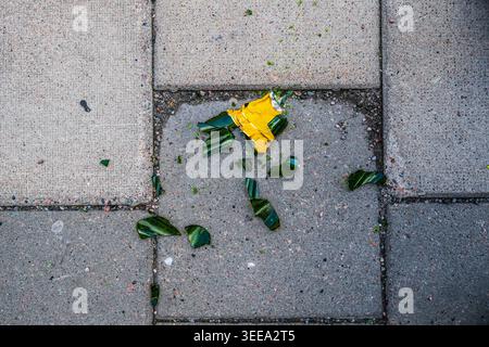 Broken green glass beer bottle on the pavement Stock Photo