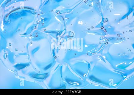 Abstract blue liquid gel with bubbles, soft glossy texture, macro close-up, clean light background. Stock Photo