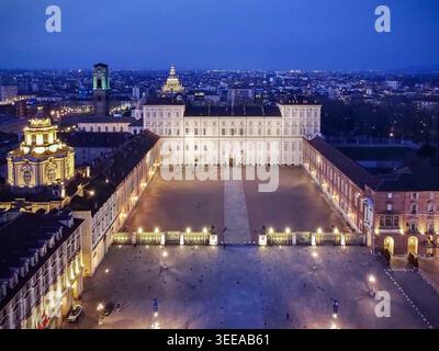Aerial view of the Royal Palace of Turin and Piazza Castello illuminated at twilight with city lights in the background Turin, Piedmont, Italy. Stock Photo