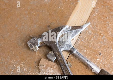 Carpenter's hammers lying on a wooden floor construction. Close-up of the tools on footfall sound absorption sheets. Equipment on a construction site. Stock Photo