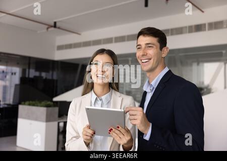 Young business team collaborating on project using digital tablet Stock Photo