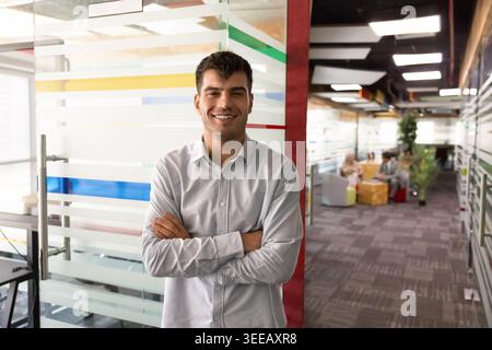 Portrait of smiling Middle Eastern businessman posing in office Stock Photo