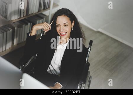 Confident female trader analyzing financial charts on multiple monitors in home office Stock Photo