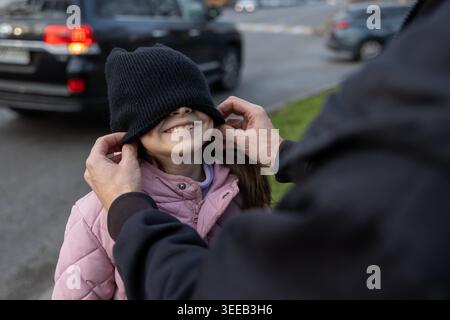 Father playing with daughter's hat Stock Photo