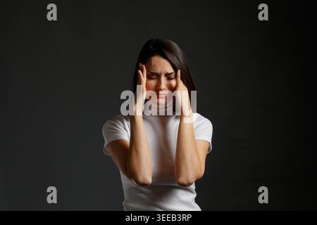 Woman suffering from intense headache Stock Photo