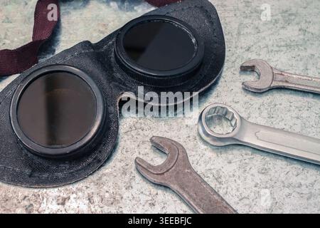 Crafting glasses and wrenches on metal background Stock Photo