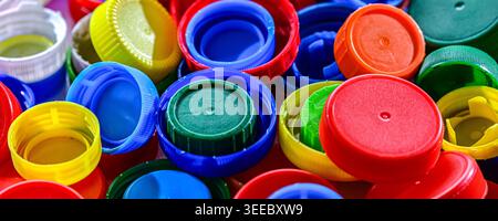 Different sorts of colorful plastic bottle caps. Recycling. Stock Photo