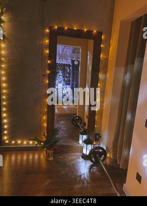 Cozy apartment interior with mirror and Christmas lights, warm festive atmosphere Stock Photo