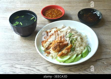 steamed rice topping chop crispy fried and boiled chicken on plate with chili sauce couple soup Stock Photo