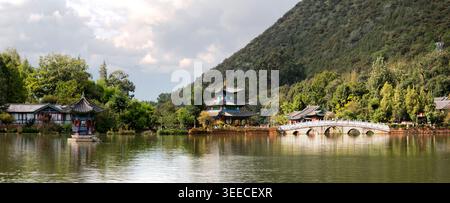 Black Dragon Pond Park. Jade Dragon Snow Mountain, chinese pavilion and bridge. Located in Lijiang, Yunnan, China. Stock Photo