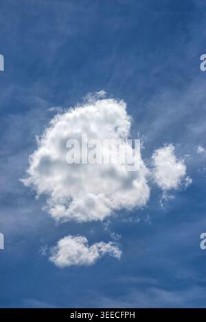 Isolated fluffy cumulus cloud floating in a clear bright blue summer sky for nature background Stock Photo
