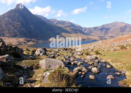 Aaron Lloer stream running down to Llyn Ogwen in Ogwen Valley with Tryfan peak and the Glyderau  range in the background, Eryri National Park, fomaly Stock Photo