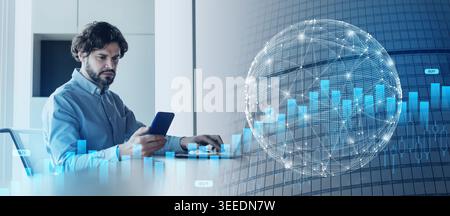 Portrait of focusedman using smartphone and pc at office Stock Photo