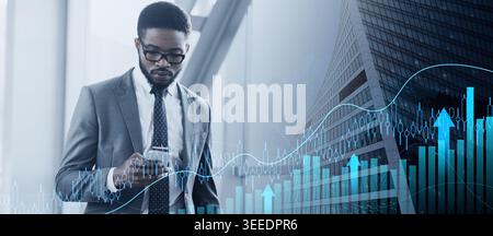 Businessman Texting on Smartphone Walking in Airport Terminal Stock Photo