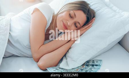 Woman Sleeping Peacefully With Cash on Bed in a Bright Room Stock Photo