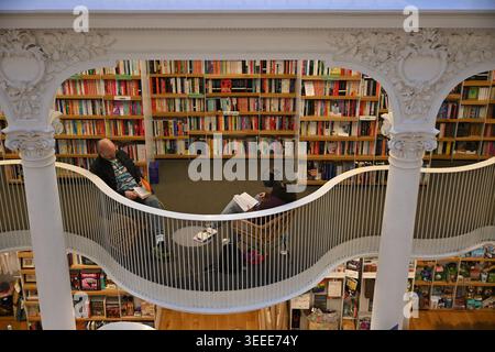 Two people reading books inside Carturesti Carusel, an historical bookstore in Lipscani, the old town of Bucharest, Romania Stock Photo
