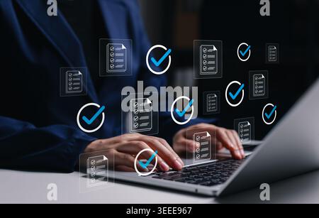 Document checklist approval and workflow verification concept. Professional using laptop with approved files, check marks, task validation, compliance Stock Photo