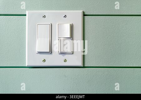 Detail of different sizes of rocker switches on a switch plate Stock Photo