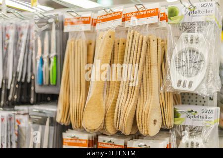 Dortmund, Germany, May 8, 2026: Kitchen utensils and bamboo cooking tools hanging in household store Stock Photo