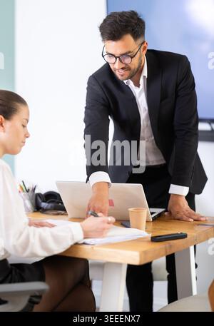 professionals working in a successful company, sit at a table Stock Photo