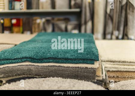 Stacked carpet samples and textile flooring materials in home improvement store Stock Photo